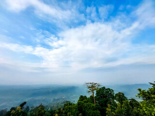 White cloud in front of blue sky of top of the hill of sajek valley