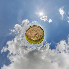 simple little tiny planet without buildings in blue sky with sun and beautiful clouds....