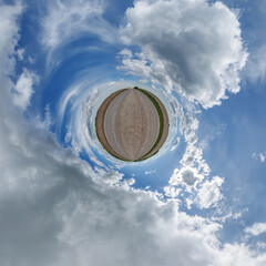 simple little tiny planet without buildings in blue sky with sun and beautiful clouds....