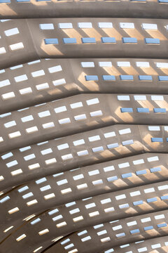 Interior curved roof structure with repetitive light grid in concrete, abstract brutalist design with pattern, geometry and minimalism