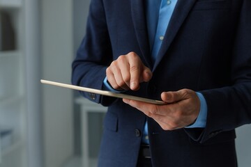 Businessman Using Digital Tablet Modern Technology Close Up Professional Corporate Executive Man in Suit Working on Tablet Device Screen Touching Business App Interface Digital Workflow blue dark data