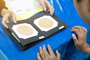 Doctor Conducting Color Blindness Test Using Ishihara Plates
