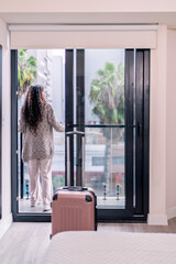 Obraz premium Digital nomad enjoying city view from airbnb balcony