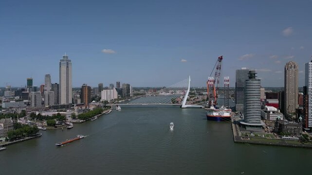 Drone view of Offshore installation vessel moored on the Nieuwe Maas near Erasmusbrug under blue sky