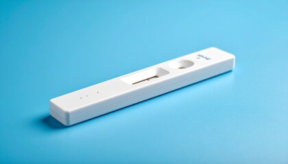 Close up photo of pregnancy test with plain blue background