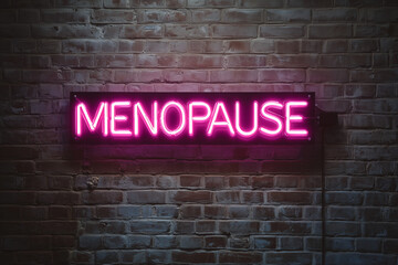 pink neon sign that says "menopause" on a plain brick wall 
