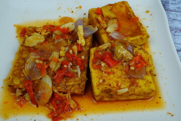 Pecak Tahu Tempe or Spicy fried tofu and tempeh with chili and shallots, a popular Indonesian dish.