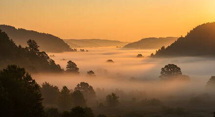 Sunrise over foggy mountain ridges