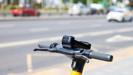 This is a detailed closeup view of the handlebars of an electric scooter