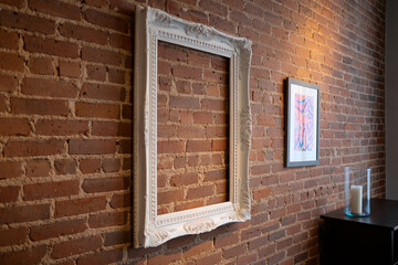 White ornate picture frame on brick wall interior design home decor art space