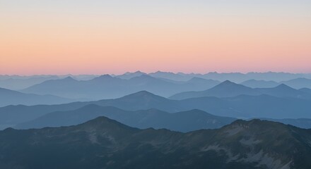 Layers of mountains under pastel morning sky