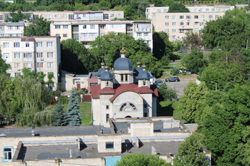 A church with a traditional architectural design standing amidst a modern urban environment. 