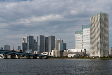 Naklejka premium Harumiohashi Bridge and district of Chuo Harumi on reclaimed land, created by dropping earth and sediment generated from expanding Tokyo Bay, Tokyo, Japan
