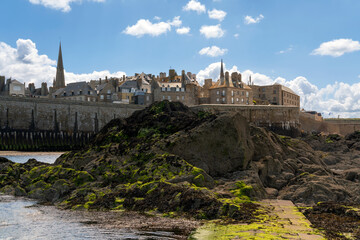 View of the fortress city of Saint-Malo on the English Channel and the ocean floor exposed at low...