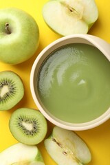 Baby food. Tasty puree in bowls and different ingredients on yellow background, flat lay