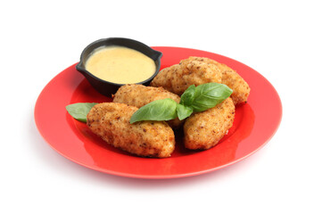 Tasty fried croquettes, basil and sauce isolated on white