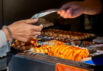 Woman buying street food, Takayama, Japan