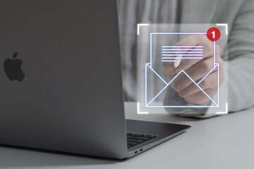 Email marketing, new message notification. Man using virtual screen near laptop at table, closeup