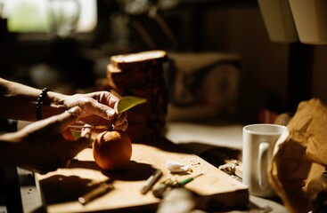 Expert hands prepare vibrant ingredients for cozonac decorations in a warm, inviting kitchen. The traditional baking atmosphere captures the essence of culinary artistry and creativity