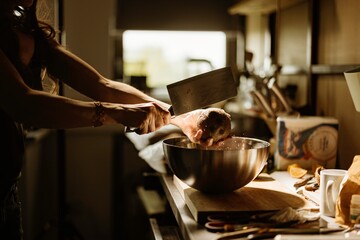 A pastry chef skillfully prepares cozonac decorations, showcasing fresh ingredients and intricate food styling. The warm kitchen radiates a sense of traditional baking craftsmanship
