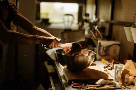 A talented pastry chef skillfully prepares ingredients for cozonac decoration, showcasing vibrant colors and textures in a warm, inviting kitchen atmosphere