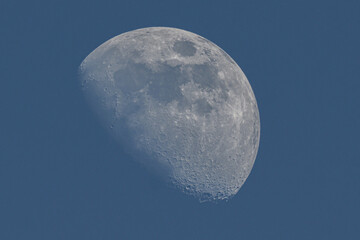 Moon phase, waxing gibbous on day blue sky. High resolution details.