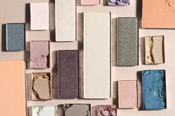 Fototapeta premium Beautiful eyeshadow refill pans on beige background, flat lay