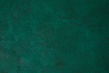 Green textured grunge wall with dark aged plaster and rough surface