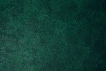 Green textured grunge wall with dark aged plaster and rough surface