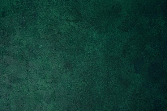 Green textured grunge wall with dark aged plaster and rough surface