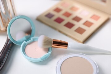 Different makeup products on white table, closeup