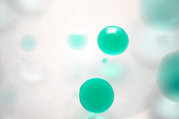 Abstract teal bubbles floating in soft white background