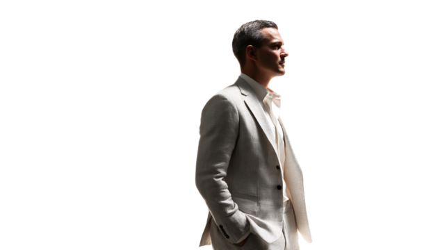 Elegant man in summer suit standing in profile, cropped to torso, white background, cinematic lighting, PNG