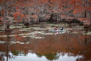 photographers in boat in swamp