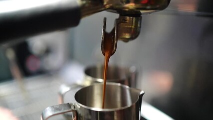 Slow motion espresso pouring into metal pitchers from coffee machine - Powered by Adobe