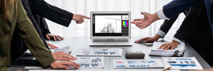 Panorama shot analyst team utilizing BI Fintech to analyze financial report with laptop....