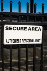 Secure area sign on metal gate, USA