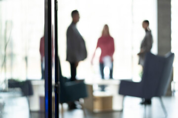 Defocused bokeh effect positive concept background of unrecognizable people business team