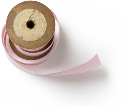 A wooden spool holding a pink ribbon, often used for crafts, sewing, or decorative purposes.