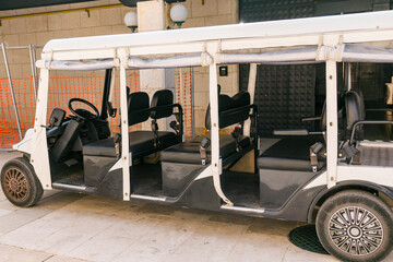 Electric shuttle cart for resort guests. Coastal relaxation, vacation ambiance and summer leisure...