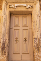 Malta, Birgu. Collegiate Parish Church of Saint Lawrence. Exterior. Door detail with Maltese Cross.