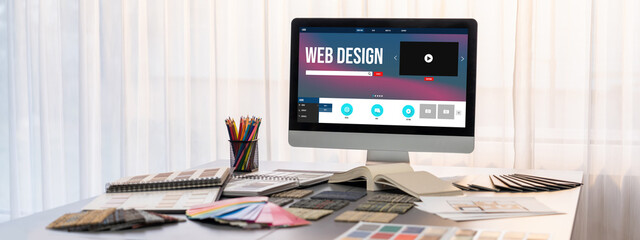 Interior designer workspace table and architecture software on laptop screen with mood board...