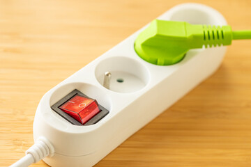 Electricity price. Energy fees and bills. Financial and economic concept. power strip with a plug and a green plug. cost of energy transformation