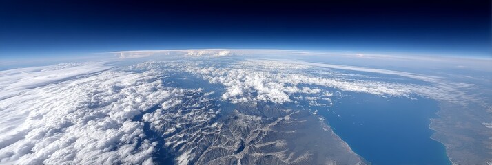 Earth's Curve and Cloud Formations - Stunning aerial view of Earth's curvature, showcasing a vast expanse of clouds and mountainous terrain. Breathtaking landscape