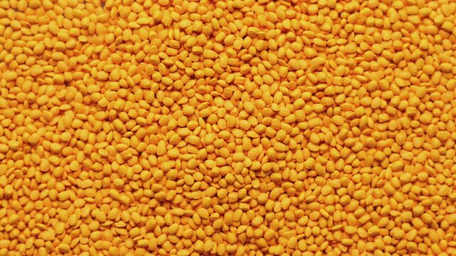 Orange polymer dye in granules, background texture