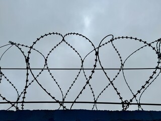 metal wire, fence on the background of the sky. High quality photo