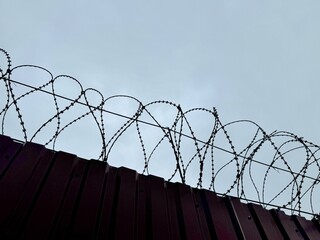 metal wire, fence on the background of the sky. High quality photo