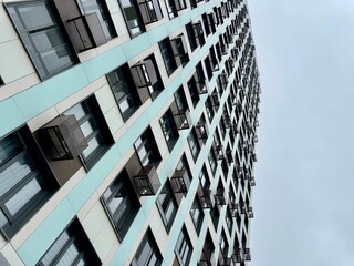 A high-rise apartment building on a blue sky background. New building. High quality photo