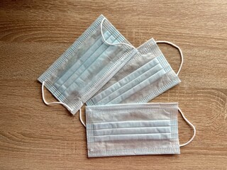 Three blue medical masks are on the table. High quality photo