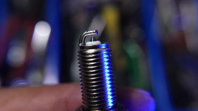 Close-Up View of a Spark Plug with Industrial Background